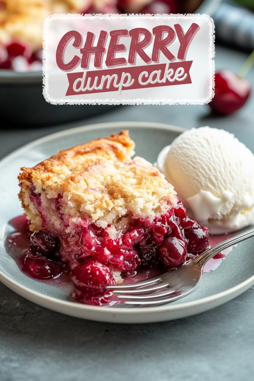 A slice of cherry dump cake served on a gray plate with vanilla ice cream. The dessert features a golden, flaky crust with vibrant, juicy cherry filling spilling onto the plate. A silver fork rests beside the cake. Background shows blurred cherries and a baking dish. Text overlay reads "Cherry Dump Cake."