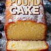A cream cheese pound cake dusted with powdered sugar, showcasing a golden crust and soft, fluffy texture, with "Cream Cheese Pound Cake" text overlay in bold.