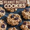 A collection of oatmeal raisin peanut butter cookies displayed on a dark marble surface. The cookies are arranged in a grid, showcasing their rustic texture with oats and raisins prominently visible. Overlay text in bold vintage font reads, "Oatmeal Raisin Peanut Butter Cookies."