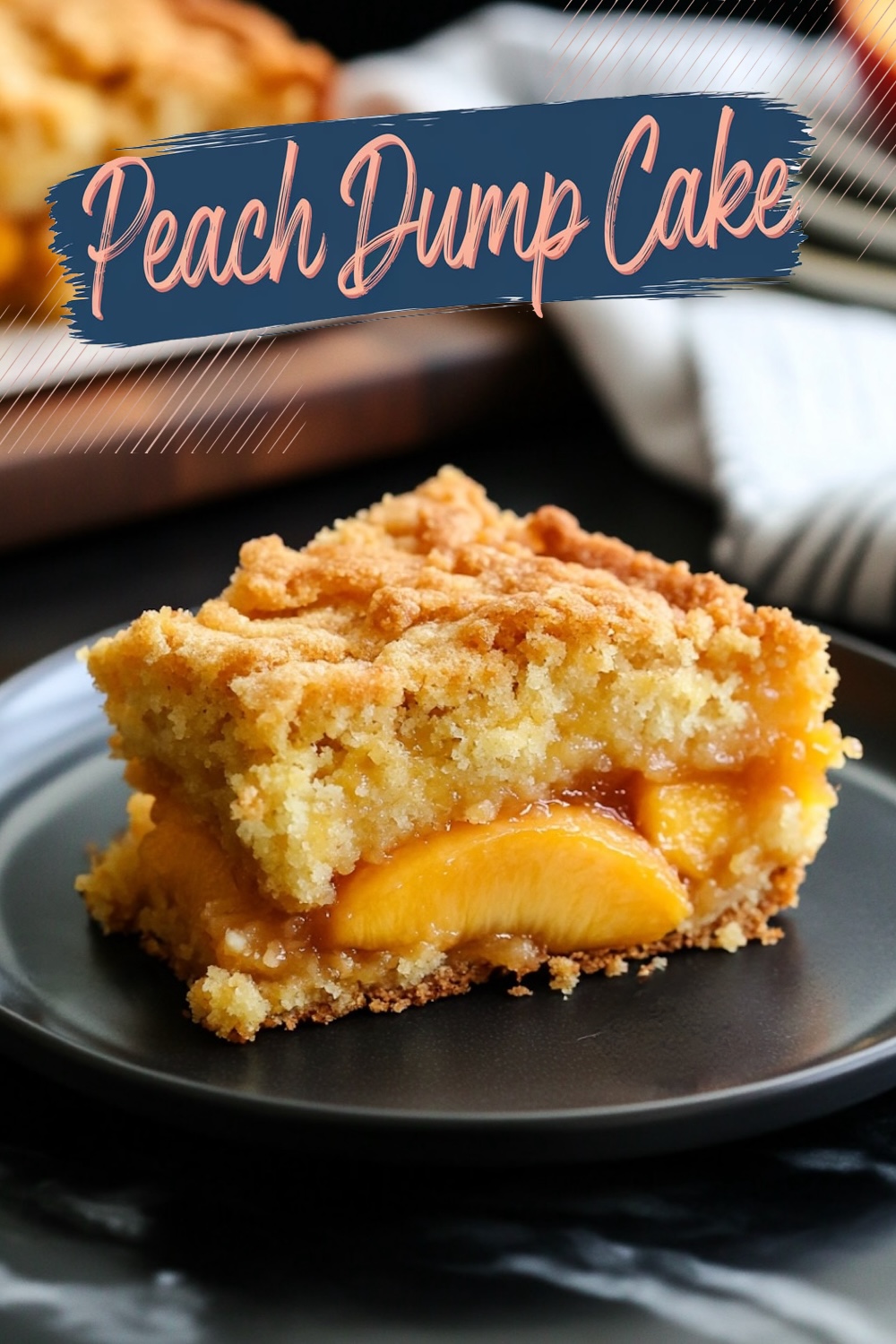 A close-up of a single slice of peach dump cake served on a black plate. The warm peaches, syrupy filling, and crispy buttery topping create a visually appealing dessert perfect for casual or holiday servings.