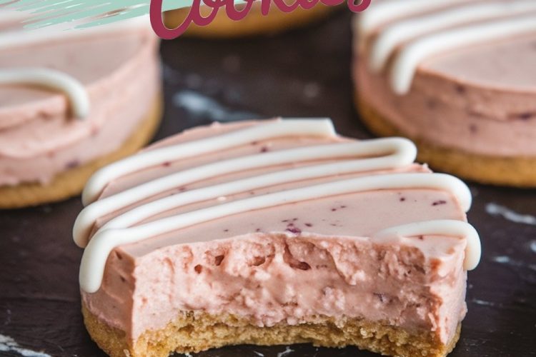 A close-up of a single strawberry cheesecake cookie with a bite taken out, revealing the creamy pink filling and crumbly cookie crust. The icing drizzle and visible strawberry pieces enhance the dessert’s visual appeal, making it an irresistible treat.
