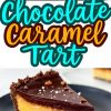A rich chocolate caramel tart with a glossy chocolate ganache topping, sprinkled with flaky sea salt and chocolate shavings. The tart has a chocolate crust, a smooth caramel filling, and a decadent chocolate layer. A slice is served on a black plate, showcasing the creamy texture. The bold text overlay reads “Chocolate Caramel Tart” in vibrant lettering.