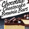 Close-up of a chocolate cheesecake brownie bar on a dark surface, highlighting the layered structure with chocolate curls and sea salt garnishing the glossy ganache topping.