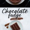 Close-up of a chocolate fudge cake with spiral frosting, garnished with chocolate shavings. Below, a slice of cake is plated on a white dish over a marble background, surrounded by chocolate brushstroke decorations. Text overlay reads “Chocolate Fudge Cake.”