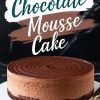A rich chocolate mousse cake with a smooth, layered design, featuring a swirled top and dark chocolate crust, displayed on a white plate with a gold spoon. Text overlay reads, “Chocolate Mousse Cake.”