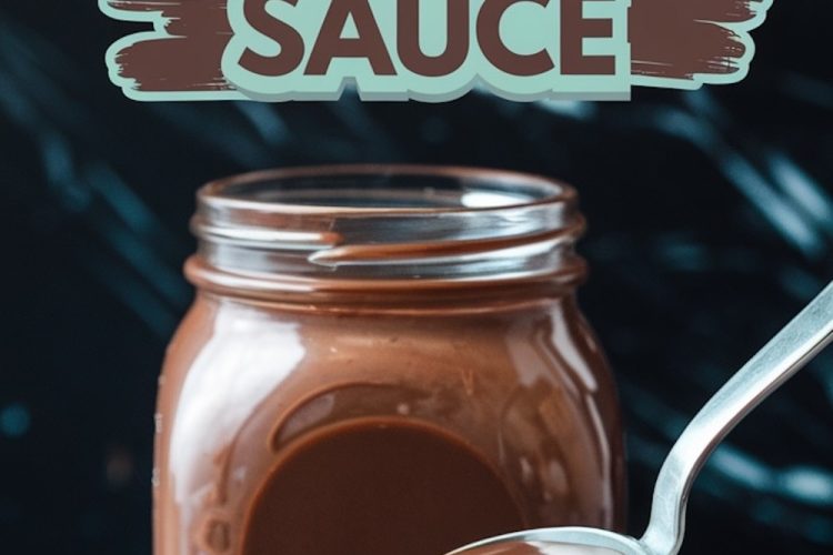 A glass jar filled with creamy homemade hot fudge sauce, with a silver spoon drizzling the rich chocolate sauce. The text overlay reads, “Homemade Hot Fudge Sauce,” on a dark marble background.