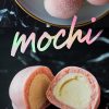 A bowl of soft, pastel-pink mochi dusted with powdered sugar is shown above a close-up of halved mochi revealing a creamy ice cream filling. The vibrant text “Mochi” in gradient lettering appears prominently.