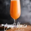 A single champagne flute filled with bright orange carrot mimosa placed on a wooden surface with a dark, blurred background. The stylish typography below the glass reads “Carrot Mimosa” and “elegant champagne flute,” enhancing the sophisticated presentation.