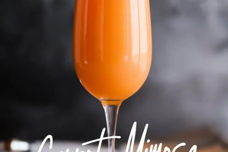 A single champagne flute filled with bright orange carrot mimosa placed on a wooden surface with a dark, blurred background. The stylish typography below the glass reads “Carrot Mimosa” and “elegant champagne flute,” enhancing the sophisticated presentation.