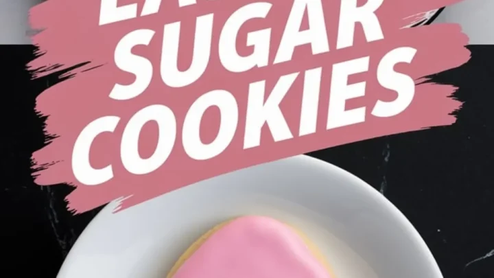 A tray of Easter sugar cookies decorated with floral designs, featuring hand-piped daisies, tiny white blossoms, and yellow flowers with green grass details. A pink egg cookie with three white daisies is placed on a white plate. Bold pink brushstroke text reads “Easter Sugar Cookies.”