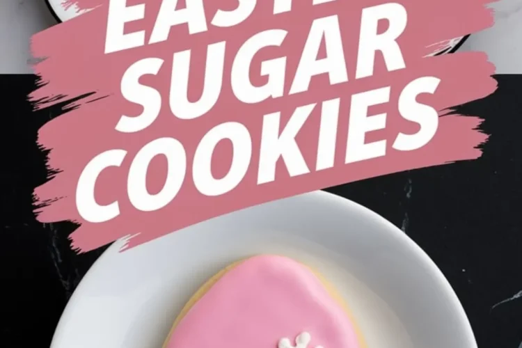 A tray of Easter sugar cookies decorated with floral designs, featuring hand-piped daisies, tiny white blossoms, and yellow flowers with green grass details. A pink egg cookie with three white daisies is placed on a white plate. Bold pink brushstroke text reads “Easter Sugar Cookies.”