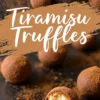 Tiramisu truffles on a dark surface with a rustic cocoa-dusted background. One truffle is bitten into, revealing a soft, creamy interior. A text overlay reads “Tiramisu Truffles” in bold white script, highlighting the dessert’s name.