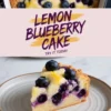 Round lemon blueberry cake topped with fresh blueberries and lemon zest, shown in a baking dish with a slice plated on a beige ceramic plate. The cake has a golden crust and soft, moist interior with baked blueberries. Text overlay reads “Lemon Blueberry Cake – Try It Today.”