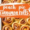 Freshly baked peach cinnamon rolls in a white rectangular baking pan, filled with cinnamon swirl and diced peaches, lightly topped with icing.