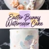 A pastel Easter bunny watercolor cake with soft painted-style frosting in pink, blue, and purple shades, adorned with peach roses, tiny flowers, and a fondant bunny, displayed on a white cake stand, with “Easter Bunny Watercolor Cake” text overlay.