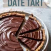 Chocolate date tart with clean slices revealing ganache filling and date layer, presented in a white tart dish. Highlight on smooth texture, rich filling, and clean cut portions.