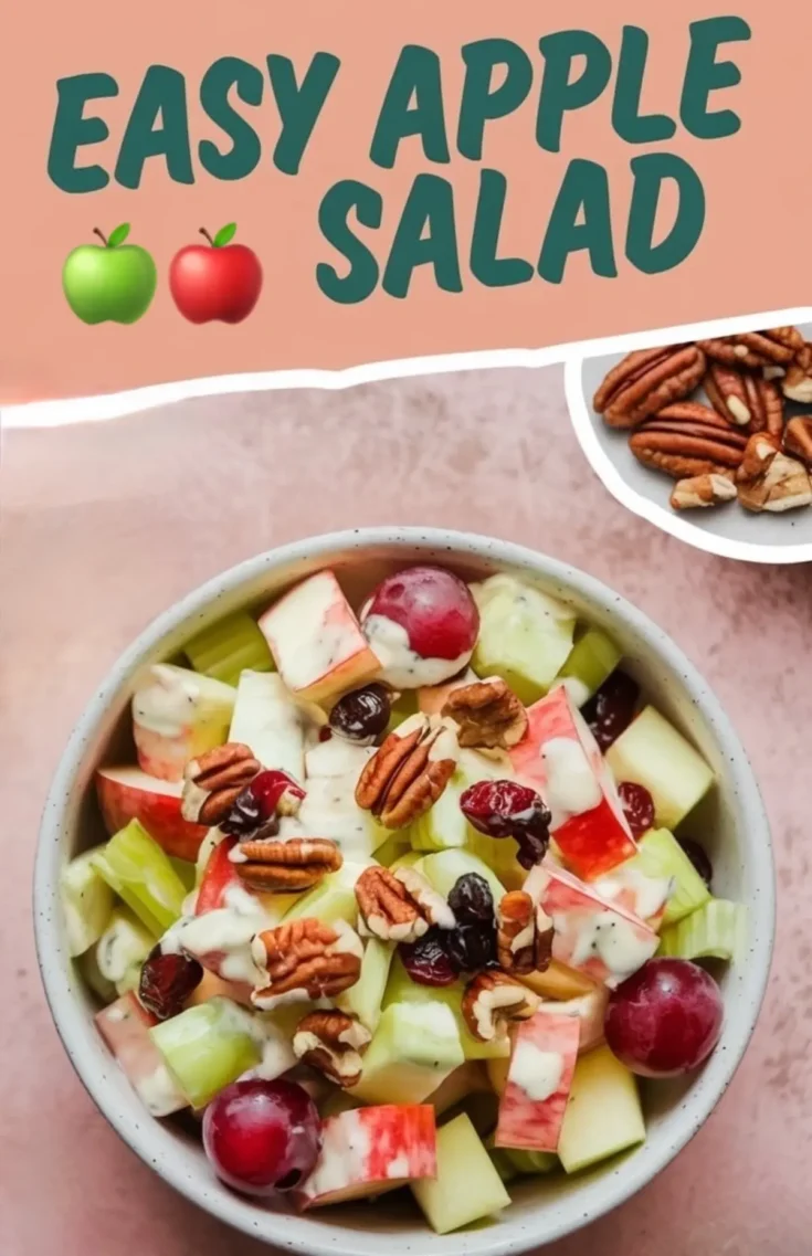 Top view of an apple salad featuring green and red apple chunks, red grapes, celery pieces, dried cranberries, and pecans, all coated in a creamy dressing and served in a speckled bowl with text overlay that reads “Easy Apple Salad.”