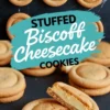 Close-up of stuffed Biscoff cheesecake cookies arranged on a dark slate surface, with one cookie cut open to reveal a creamy cheesecake filling inside a golden brown cookie shell.