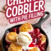 Homemade cherry cobbler served in a black cast iron pan, featuring golden brown biscuits and melting vanilla ice cream over glossy cherry pie filling.