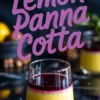 Single serving of lemon panna cotta in a clear glass with smooth lemon custard base and a glossy blueberry compote topping, styled on a black marble table with blurred ingredients in the background.