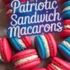 Close-up image of red and blue macarons with creamy white filling arranged in a circle around a “Patriotic Sandwich Macarons” text overlay, highlighting Fourth of July dessert aesthetics.