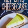 Key lime cheesecake slice with smooth, glossy lime topping on a white plate, gold fork placed beside, with bold “Key Lime Cheesecake” text overlay on a dark background.