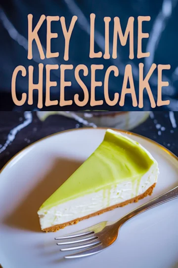 Key lime cheesecake slice with smooth, glossy lime topping on a white plate, gold fork placed beside, with bold “Key Lime Cheesecake” text overlay on a dark background.