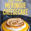 A fully assembled lemon meringue cheesecake with a golden-brown toasted meringue swirl on top of vibrant lemon curd, displayed on a white plate with bold text reading “Lemon Meringue Cheesecake.”