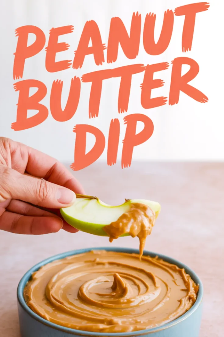 Hand holding a green apple slice dipped into creamy peanut butter dip, with a bowl of smooth peanut butter spread below and bold orange text reading “Peanut Butter Dip.”