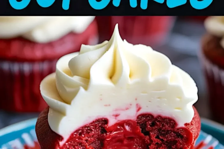 Red velvet cupcake with a bite taken out, revealing its vibrant red interior and moist texture. The creamy swirl of frosting sits atop the rich cupcake on a blue plate.