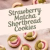 Overhead view of baked strawberry matcha shortbread cookies placed on parchment paper, showcasing bold green matcha and pink strawberry dough swirled into soft, round cookies.