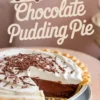 Chocolate pudding pie with whipped cream topping and chocolate shavings, partially sliced to reveal the smooth, rich chocolate filling, with a text overlay reading “Old Fashioned Chocolate Pudding Pie.”