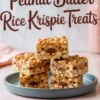 Stack of peanut butter Rice Krispie treats on a blue plate, layered with melted chocolate and topped with a peanut butter drizzle, with text in the background reading “Peanut Butter Rice Krispie Treats.”