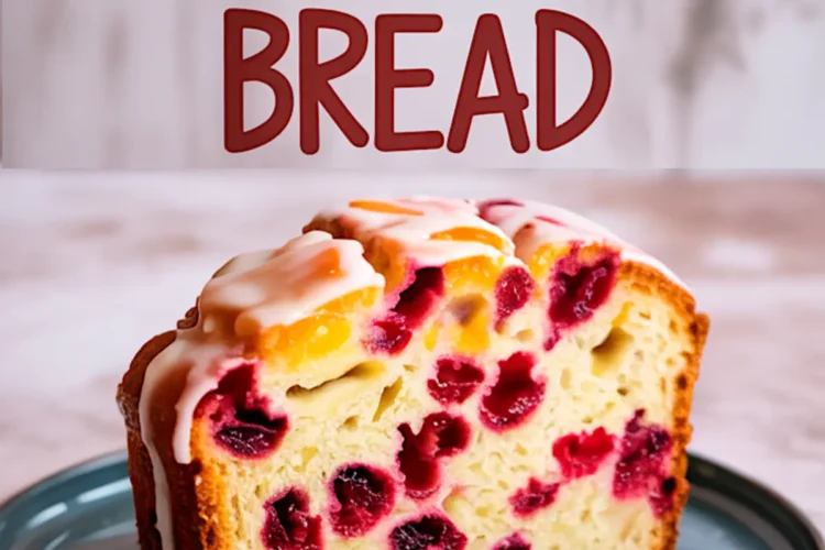 Moist cranberry orange bread slice on a blue plate, showing vibrant red cranberries and orange zest inside a soft, golden loaf, topped with citrus glaze and text above reading “Cranberry Orange Bread.”