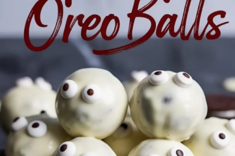 Close-up of stacked ghost-themed Oreo balls with candy eyes and white chocolate coating, placed on a dark reflective surface with Halloween dessert text overlay.
