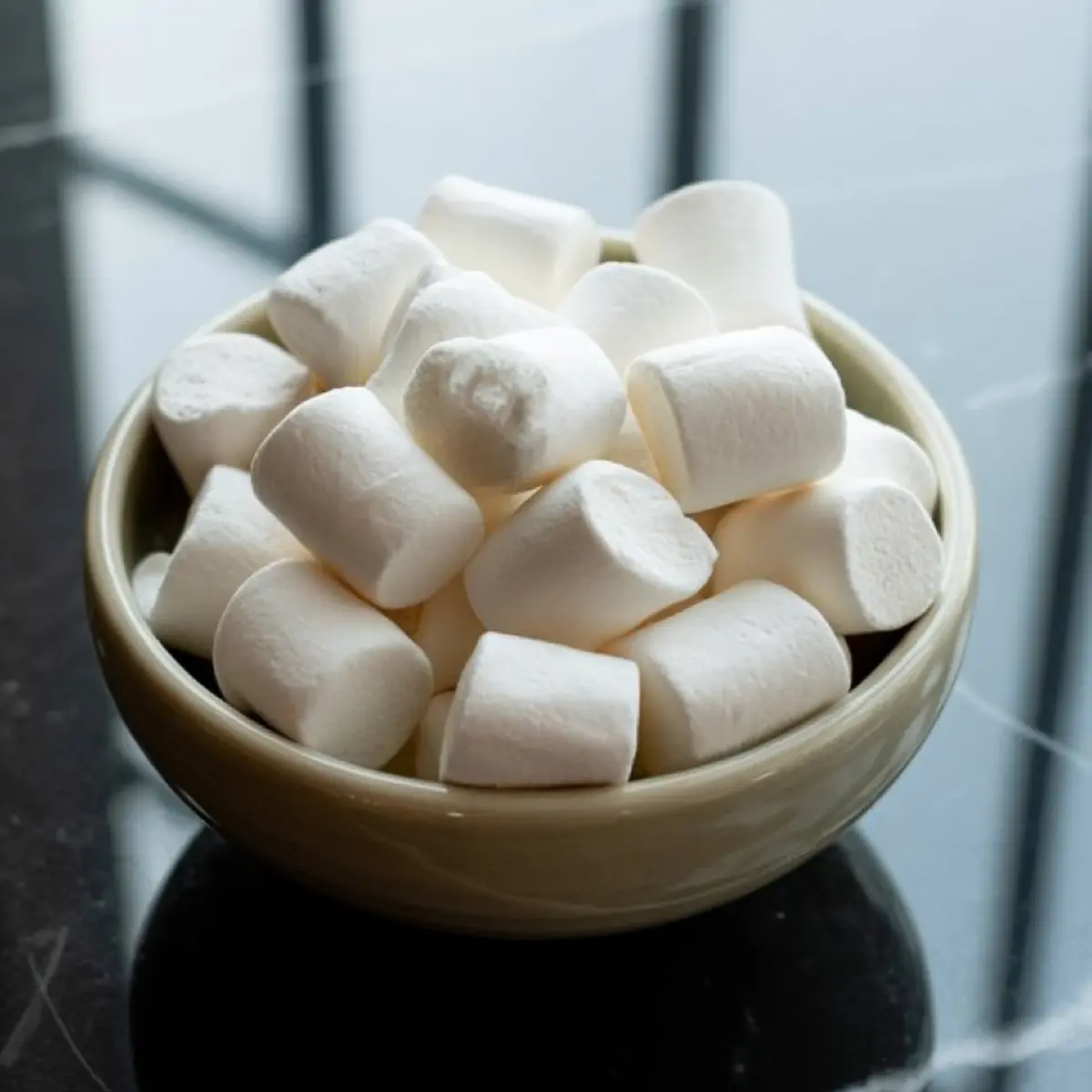 Bowl filled with fluffy white marshmallows, ready to be used for s’mores, hot cocoa, or sweet holiday treats.