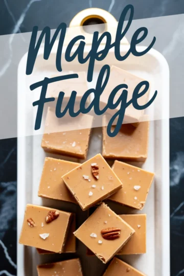 Close-up view of maple fudge squares in a serving tray, garnished with pecans and sea salt flakes, with a “Maple Fudge” text overlay.