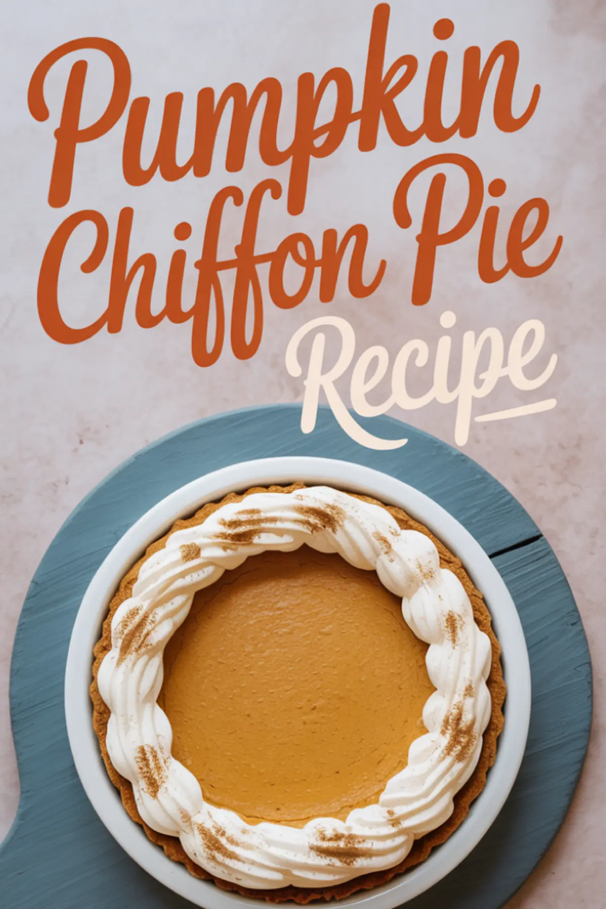 Overhead view of a finished pumpkin chiffon pie on a blue cake stand, topped with piped whipped cream and a sprinkle of cinnamon, with “Pumpkin Chiffon Pie Recipe” text overlay in bold fonts.