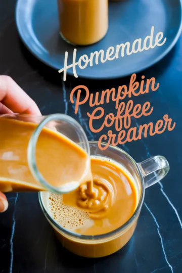 Homemade pumpkin coffee creamer being poured into a glass mug of coffee, with text overlay reading “Homemade Pumpkin Coffee Creamer.”