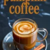 Pumpkin coffee in a clear glass mug topped with swirled cream and sprinkled cinnamon, served on a gray saucer with cinnamon sticks, with “pumpkin coffee” text in bold lettering above.