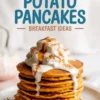 Stack of sweet potato pancakes topped with whipped cream, cinnamon, and maple syrup on a white plate, with a fork resting beside, promoting breakfast ideas.