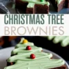 Collage showcasing close-up and top views of Christmas tree brownies with piped green frosting and colorful candy decorations, framed by “CHRISTMAS TREE BROWNIES” text in bold letters.