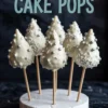 Six white chocolate Christmas tree cake pops with silver pearls and shredded coconut, arranged in a foam base under bold text reading “CHRISTMAS TREE CAKE POPS.”