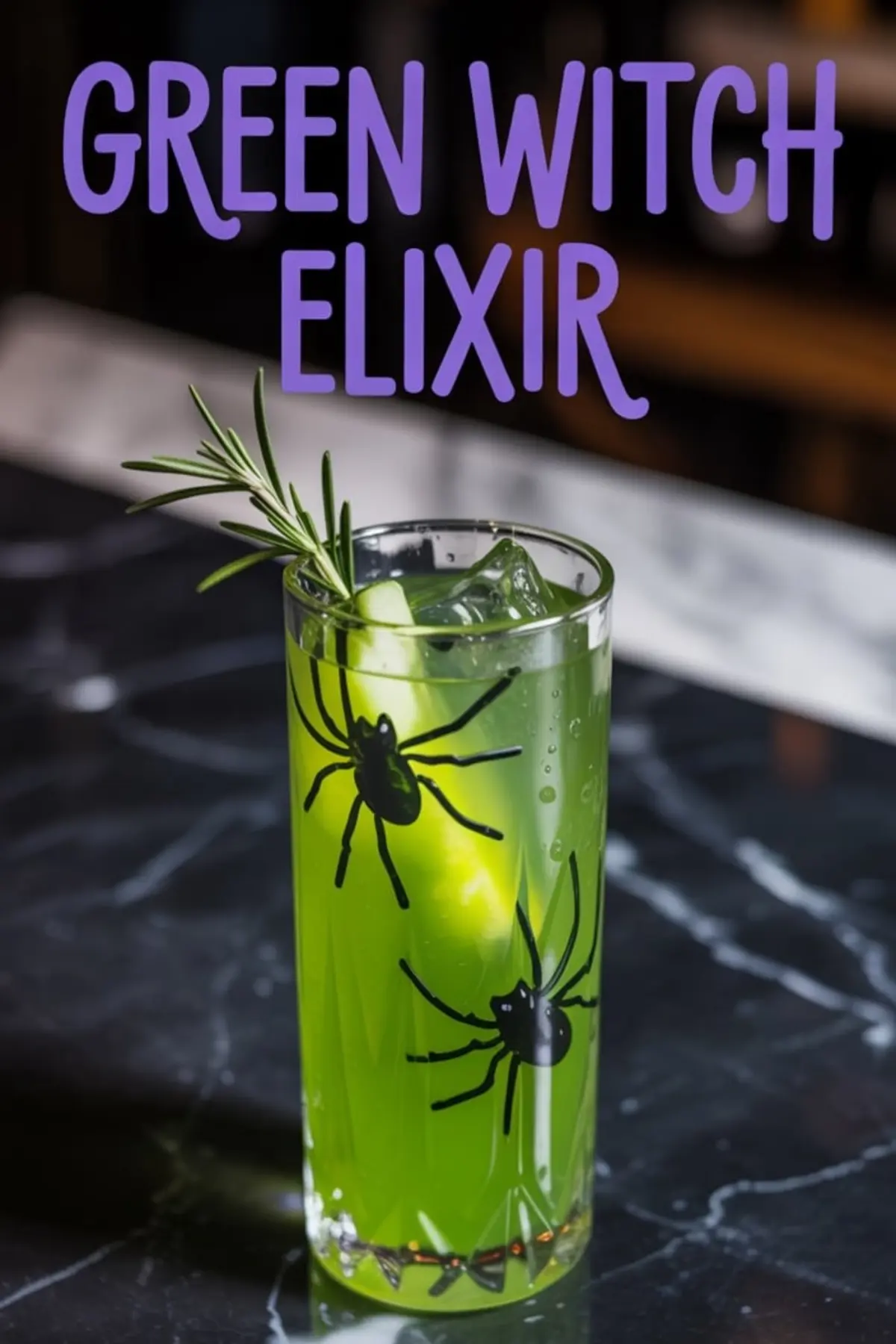 Green Halloween drink in a spider-themed tall glass with ice, rosemary sprig, and a cucumber spear, placed on a dark marble counter under bold “Green Witch Elixir” text.
