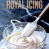 Glass bowl of freshly made royal icing with a spatula lifting the icing, surrounded by piped icing lines and a “how to make ROYAL ICING” text overlay.