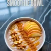 Apple cinnamon smoothie bowl garnished with fresh apple slices, whole walnuts, cinnamon powder, and golden honey drizzle, with text overlay reading “Apple Cinnamon Smoothie Bowl.”
