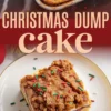 Slice of Christmas dump cake topped with cinnamon crumble and red and green sprinkles on a white plate, layered with cherry filling and yellow cake, with the full cake shown partially above the text overlay.