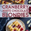 Eye-catching Pinterest graphic displaying blondie squares with creamy drizzle, large modern block title, bottom plate view of a bar beside artistic white chocolate splashes.
