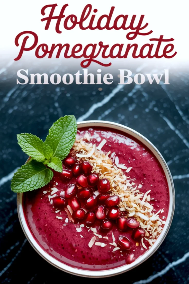 Top-down view of a vibrant pomegranate smoothie bowl with shredded coconut, pomegranate arils, and toasted coconut flakes, garnished with mint and framed by a holiday-themed text overlay on a marble surface.