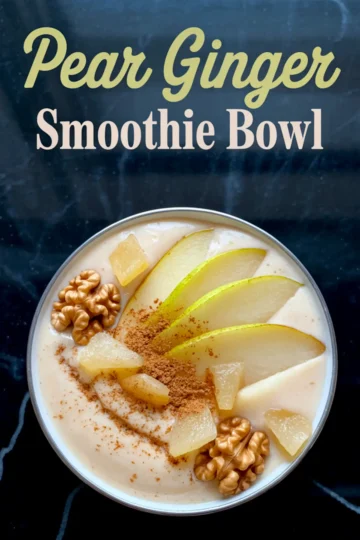 Overhead shot of a pear ginger smoothie bowl garnished with sliced pear, cinnamon, pineapple chunks, and whole walnuts on a black marbled background, with a title text overlay.